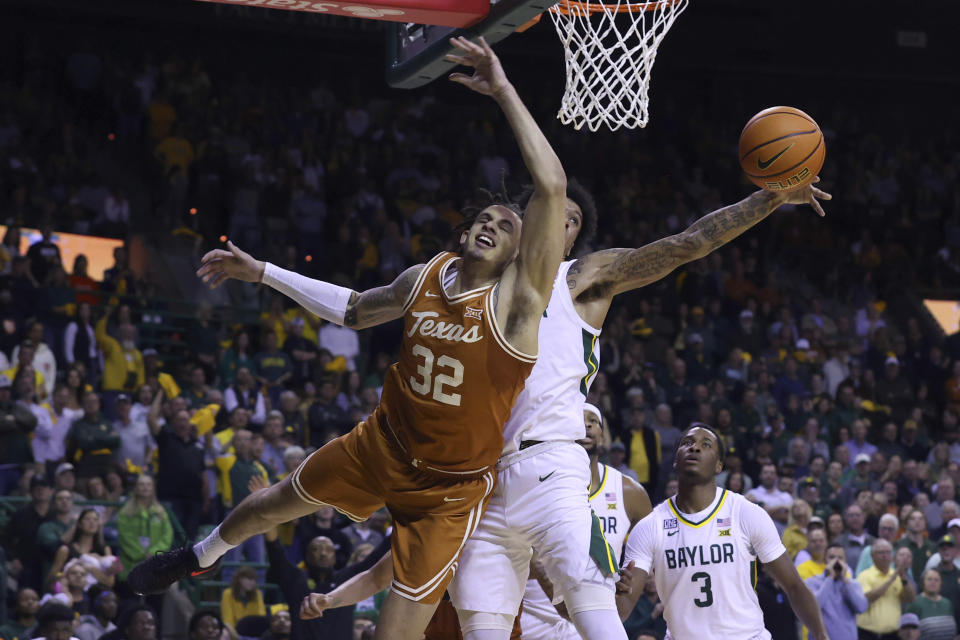 Texas forward Christian Bishop (32) has his shot blocked by Baylor forward Jalen Bridges during the first half of an NCAA college basketball game Saturday, Feb. 25, 2023, in Waco, Texas. (AP Photo/Jerry Larson)