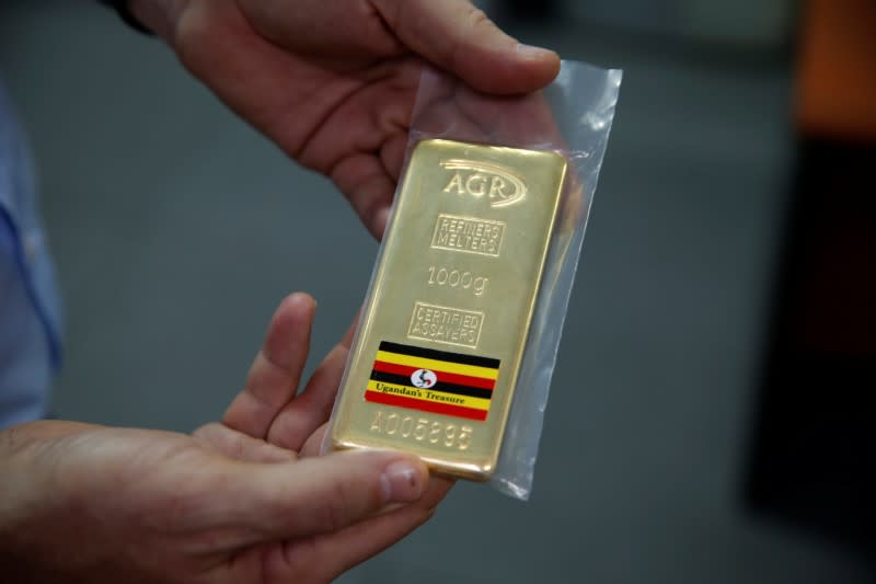 An employee holds a 1kg gold bar at AGR (African Gold Refinery) in Entebbe