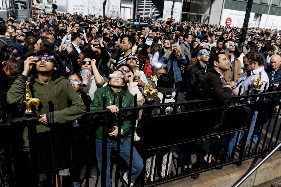 Large crowds gather around Bryant Park to witness a partial eclipse of the sun on April 8, 2024, in New York City. / Credit: Andrew Lichtenstein/Corbis via Getty Images