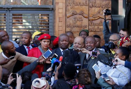 Bantu Holomisa (C), head of the United Democratic Movement (UDM), speaks to members of the media after Chief Justice Mogoeng Mogoeng made a ruling at the Constitutional Court in Johannesburg, South Africa, June 22,2017. REUTERS/Siphiwe Sibeko