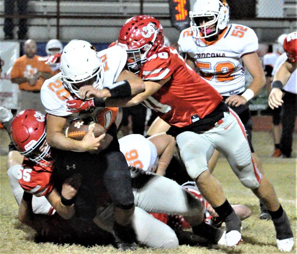 Nocona's Jonathan Stone is tackled by a swarm of Holliday defenders on Thursday, October 21, 2021 at Holliday.