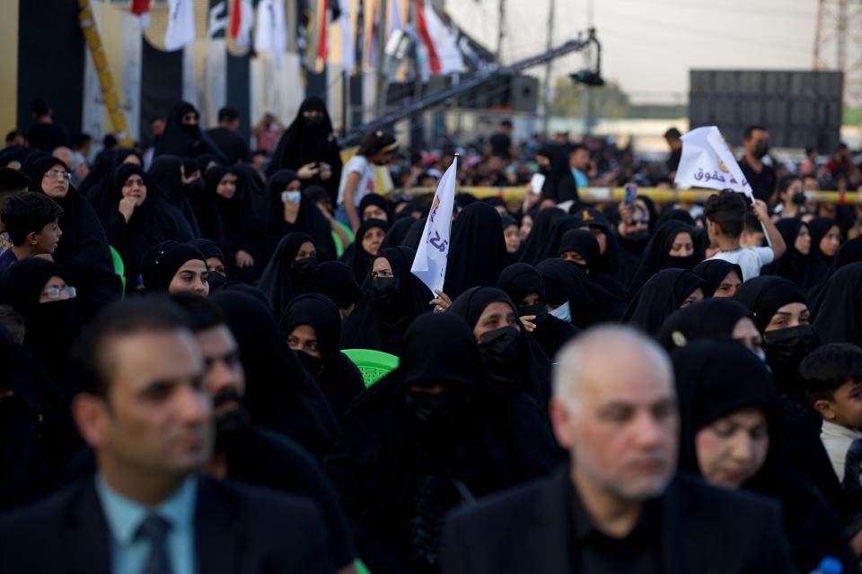 Supporters of a political movement called "Harakat Huqooq, Arabic for Rights Movement, listen to Hussein Muanis during an election rally in Baghdad, Iraq, Friday, Sept. 3, 2021. Muanis is the leader of Kataeb Hezbollah, one of the most hard-line and powerful militias with close ties to Iran, who once battled U.S. troops. He is the first to be openly affiliated with Kataeb Hezbollah or Hezbollah Brigades, signaling the militant group’s formal entry into politics. (AP Photo/Hadi Mizban)
