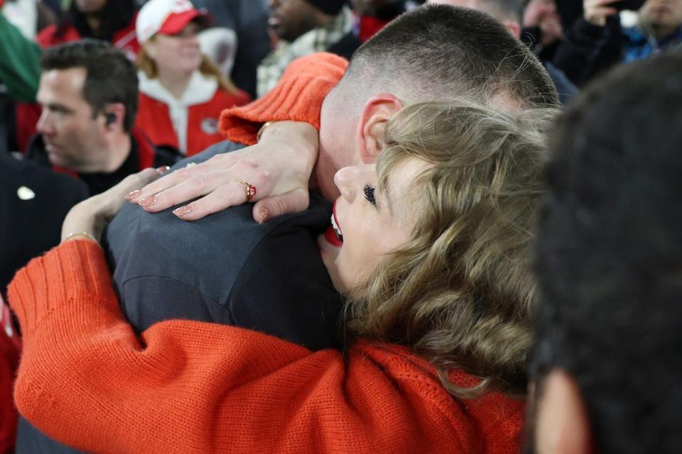 Taylor Swift hugs Travis Kelce while wearing an EB and Co. ring.