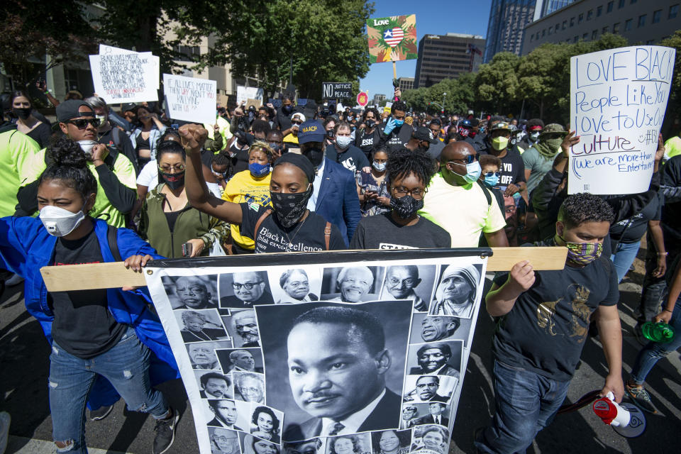 Thousands of protesters march down Capitol Mall in Sacramento, Calif., on Saturday, June 6, 2020. The protest is sparked by the death of George Floyd, who died May 25 after he was restrained by Minneapolis police. (Jason Pierce/The Sacramento Bee via AP)