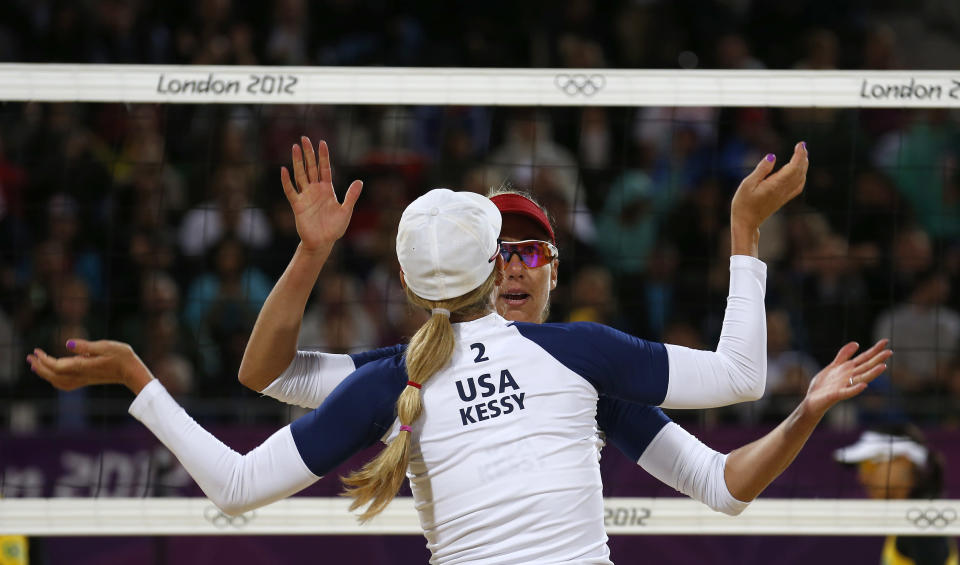 April Ross and Jennifer Kessy of the U.S. celebrate a point against Brazil's Juliana and Larissa during their women's beach volleyball semifinal match at Horse Guards Parade during the London 2012 Olympic Games August 7, 2012. REUTERS/Suzanne Plunkett (BRITAIN - Tags: OLYMPICS SPORT VOLLEYBALL TPX IMAGES OF THE DAY) 