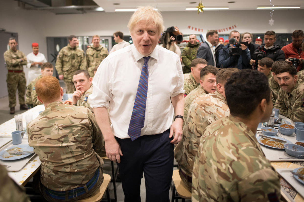 Prime Minister Boris Johnson meets soldiers after serving Christmas lunch to British troops stationed in Estonia during a one-day visit to the Baltic country. PA Photo. Picture date: Saturday December 21, 2019. The Prime Minister thanked the servicemen and women for their work as he joined them for lunch at the Tapa military base near the capital Tallinn. The base is home to 850 British troops from the Queen's Royal Hussars who lead the Nato battlegroup along with personnel from Estonia, France and Denmark. See PA story POLITICS Estonia. Photo credit should read: Stefan Rousseau/PA Wire