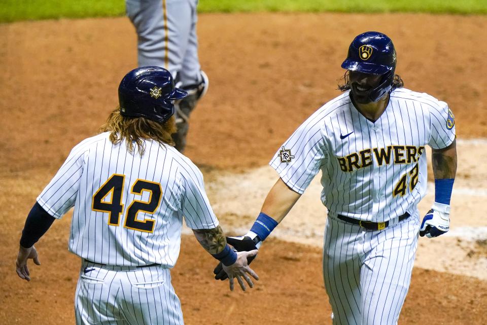 Milwaukee Brewers' Jacob Nottingham is congratulated by Ben Gamel after hitting a two-run home run during the fourth inning of a baseball game against the Pittsburgh Pirates Friday, Aug. 28, 2020, in Milwaukee. (AP Photo/Morry Gash)