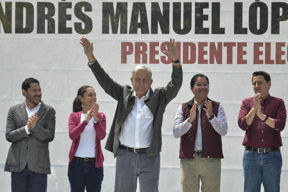 Mexico's President-elect Andres Manuel Lopez Obrador acknowledges the crowd at a rally commemorating the 50th anniversary of a bloody reprisal against students, at the Tlatelolco Plaza in Mexico City, Saturday, Sept. 29, 2018. Lopez Obrador vowed Saturday to never use military force against civilians. Troops fired on a peaceful demonstration at the plaza on Oct. 2, 1968, killing as many as 300 people at a time when leftist student movements were taking root throughout Latin America. (AP Photo/Christian Palma)