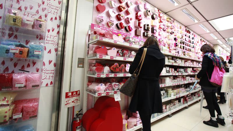 Women look at Valentine’s Day treats on sale at a store in Tokyo, Tuesday, Feb. 14, 2012. 