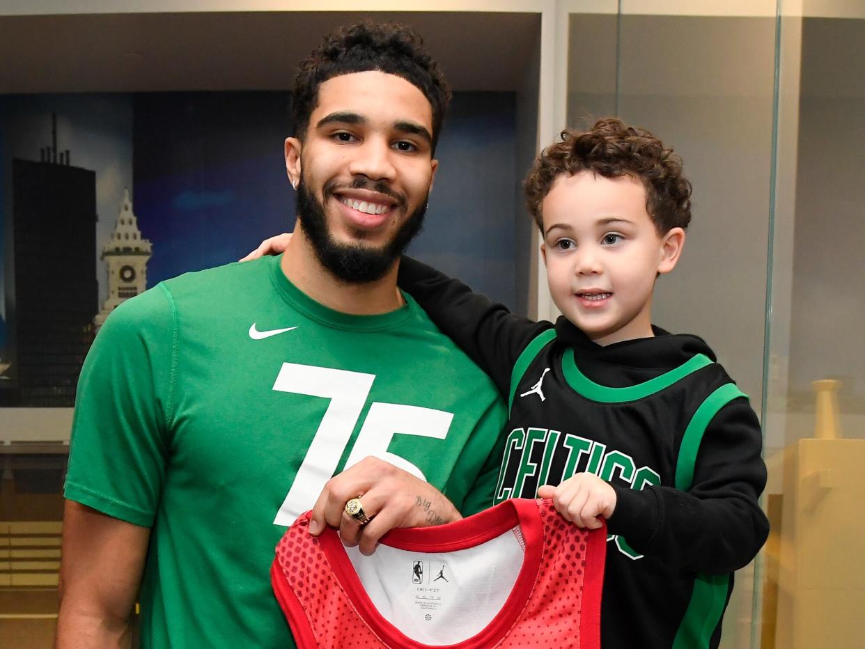 Deuce Tatum presents his dad, Jayson Tatum #0 of the Boston Celtics, with his All-Star ring before the game against the Detroit Pistons on February 16, 2022 at the TD Garden in Boston, Massachusetts