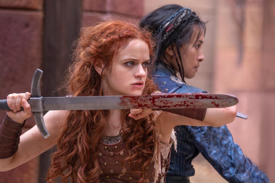Joey King (left, with Veronica Ngo) stars in "The Princess" as a strong-willed princess who, after refusing to wed a cruel sociopath, must protect her family and save the kingdom from her scorned and vengeful suitor.