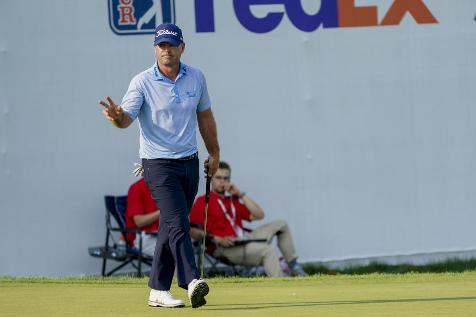 Ryan Armour acknowledges the crowd after sinking a putt for a birdie and tying for the lead on the 18th hole during the second round of the 3M Open golf tournament in Blaine, Minn., Friday, July 23, 2021. (AP Photo/Craig Lassig)