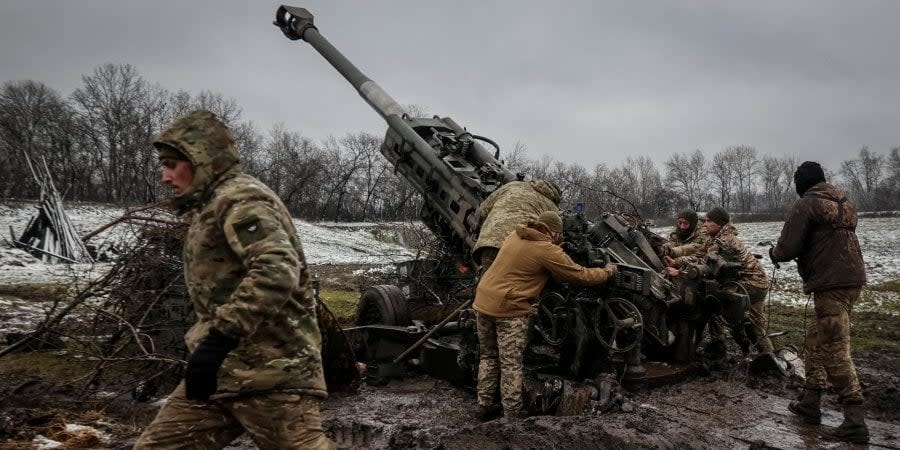 Ukrainian military personnel on the front line in the Donetsk Oblast fire from an M777 howitzer