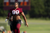 Washington Commanders defensive end Chase Young warms up during an NFL football practice at the team's training facility, Friday, July 28, 2023, in Ashburn, Va. (AP Photo/Stephanie Scarbrough)