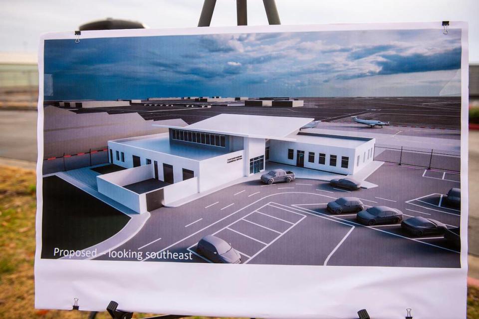 A rendering of a proposed $17 million terminal replacement project is displayed during a groundbreaking ceremony at the Merced Yosemite Regional Airport in Merced, Calif., on Thursday, Dec. 21, 2023. The project will include updates to the existing 1940s-era terminal as well as the construction of a new energy-efficient and sustainable facility. Andrew Kuhn/akuhn@mercedsun-star.com