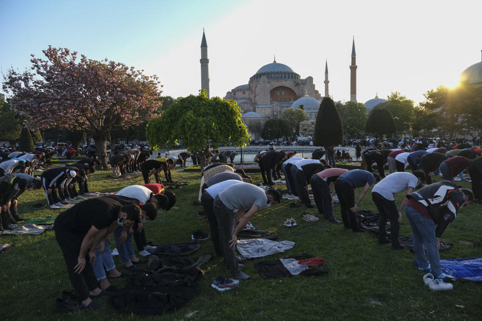 Muslims offer prayers during the first day of Eid al-Fitr, which marks the end of the holy month of Ramadan, outside the Byzantine-era Hagia Sophia, currently a mosque, in the historic Sultanahmet district of Istanbu byzantine-era Hagia Sophia in Istanbul, Thursday, May 13, 2021. Hundreds of Muslims attended dawn Eid al-Fitr prayers marking the end of the holy month of Ramadan, for the first time since the sixth-century structure, also an UNESCO World Heritage site, was reconverted into a mosque. (AP Photo)