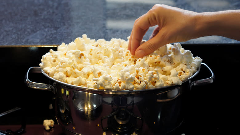 Hand grabbing popcorn