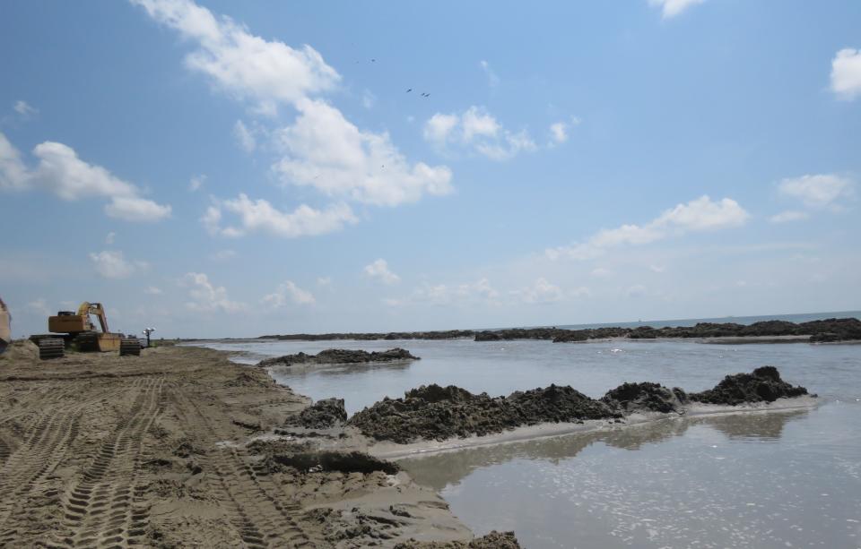 These berms along the edge of Louisiana's West Grand Terre Island on Wednesday, July 28, 2021 will guide future placement of sand dredged from five miles away. Contractors are at work on a $102 million Louisiana Coastal Restoration and Protection Authority project to add about 400 acres of beach, dune and marshland to the barrier island. Weather permitting, they hope to finish in November. (AP PHoto/Janet McConnaughey)