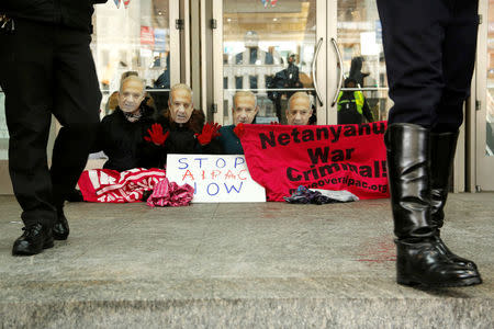 FILE PHOTO: Anti-Israel demonstrators led by the protest group Code Pink wear masks of Israeli Prime Benjamin Netanyahu as they sit at the entrance to the American Israel Public Affairs Committee (AIPAC) policy conference at the Washington Convention Center in Washington, March 1, 2015. REUTERS/Jonathan Ernst/File Photo