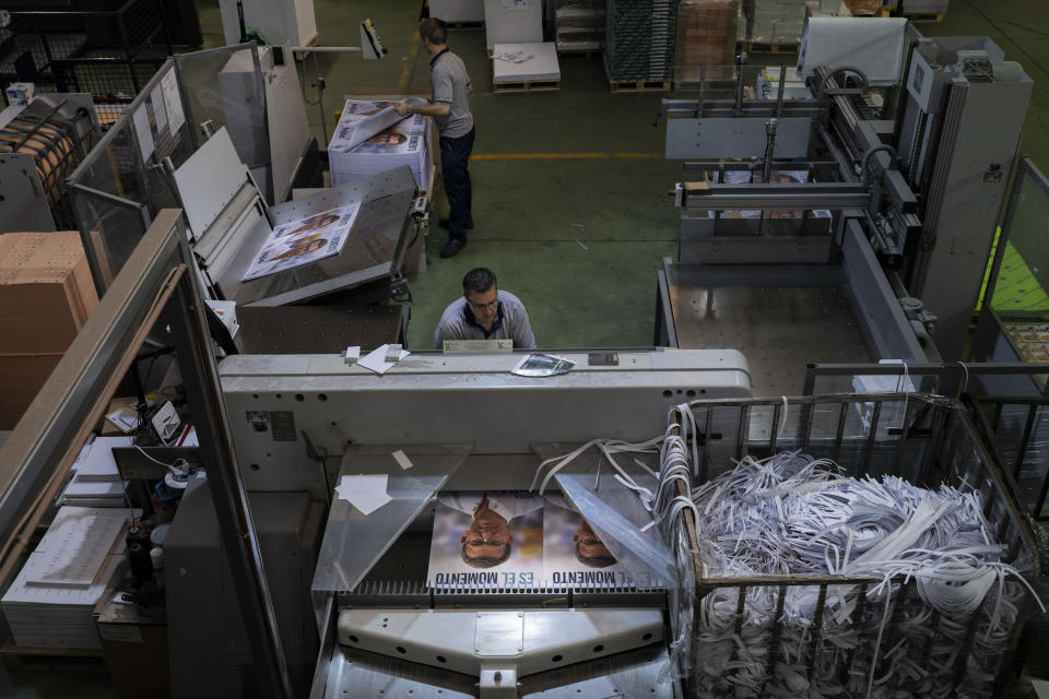 A print house staffer works on election campaign posters of center-right wing Popular Party candidate Nunez Feijoo in Madrid, Spain, Friday, June 30, 2023. A general election on Sunday July 23, 2023, could make Spain the latest European Union member to swing to the right. Prime Minister Pedro Sánchez called the early election after his Spanish Socialist Workers' Party and its far-left partner, Unidas Podemos, took a beating in local and regional elections. (AP Photo/Bernat Armangue)