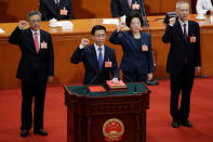 Newly elected Vice Premiers (L-R) Hu Chunhua, Han Zheng, Sun Chunlan and Liu He take an oath to the constitution at the seventh plenary session of the National People's Congress (NPC) at the Great Hall of the People in Beijing, China March 19, 2018. REUTERS/Jason Lee