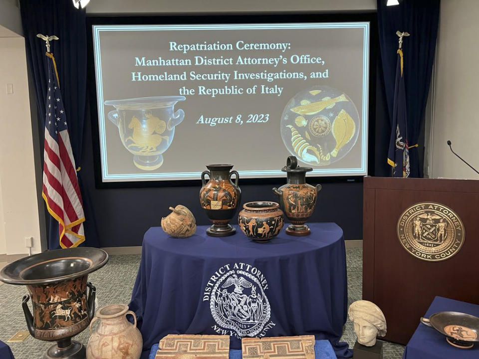 In this picture made available by the Italian Carabinieri, paramilitary police, Friday, Aug. 11, 2023, some of the 266 266 antiquities returned from the United States to Italy are displayed during a handing over ceremony t the offices of the Manhattan district attorney. Italy on Friday celebrated the return of 266 antiquities from the United States, including Etruscan vases and ancient Roman coins and mosaics worth tens of millions of euros (dollars), that were looted from Italian soil and sold to U.S. museums and private collectors. (Italian Carabinieri Via AP)