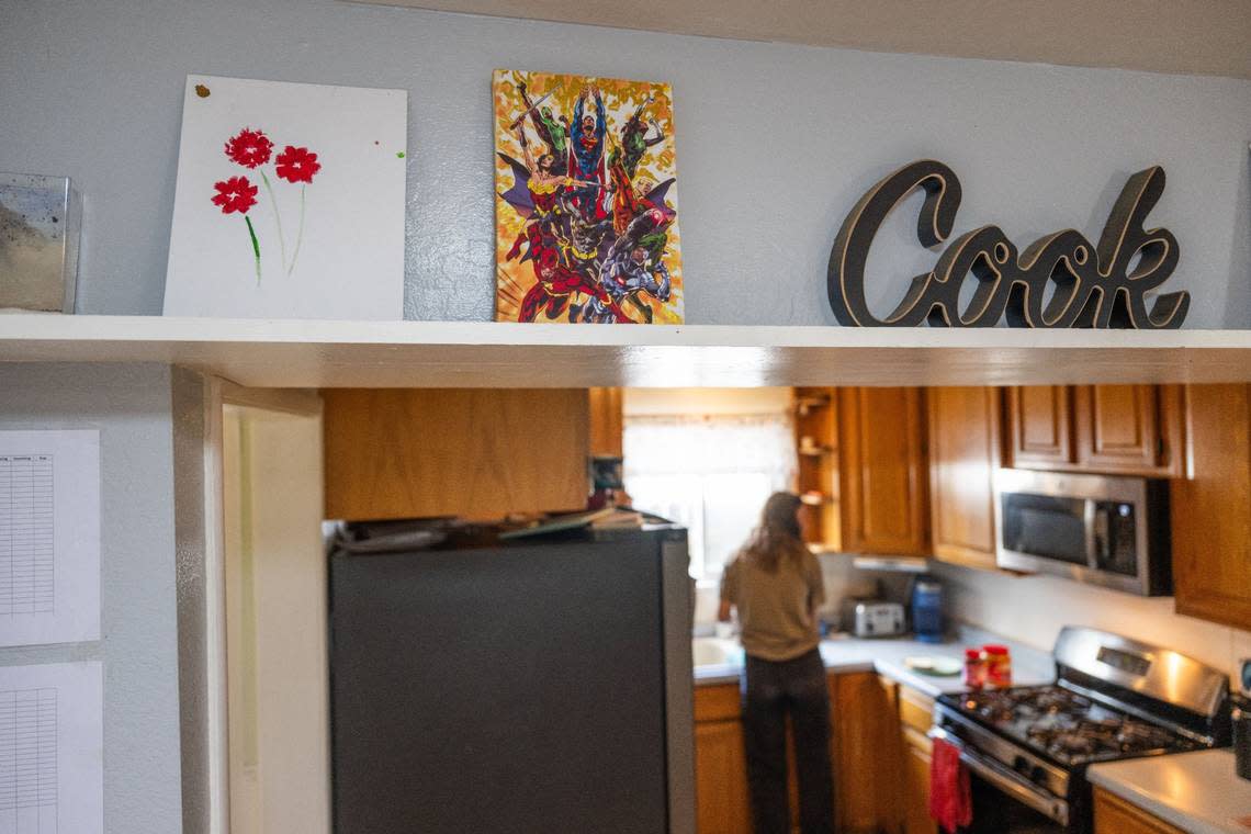An employee prepares a sandwich in April at Progress Ranch, a Davis short-term residential therapeutic facility for boys ages 6-13 who need full-time care. Artwork that the children have made in the past hangs on a shelf. Hector Amezcua/hamezcua@sacbee.com