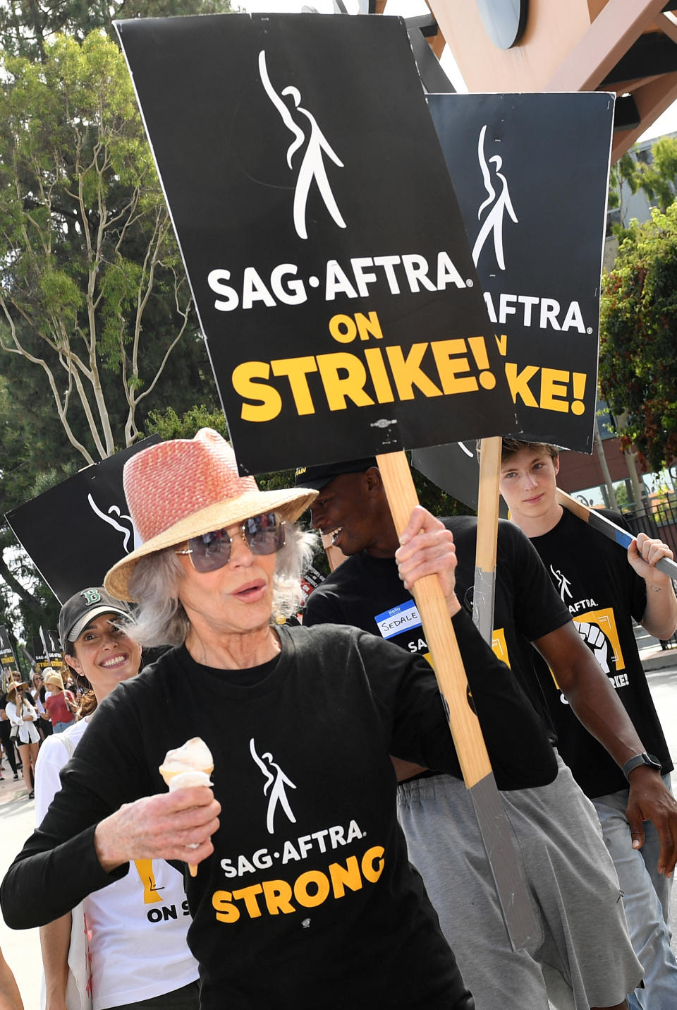 US actress Jane Fonda joins members of the Writers Guild of America and the Screen Actors Guild as they walk a picket line outside of Walt Disney Studios in Burbank, California. Photo by VALERIE MACON/AFP via Getty Images.