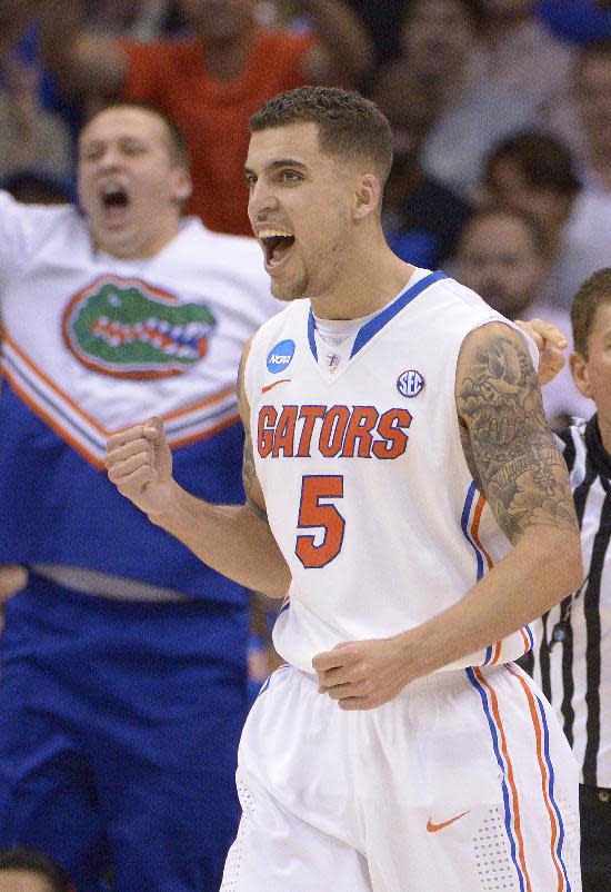 Florida guard Scottie Wilbekin (5) celebrates a basket during the second half in a third-round game in the NCAA college basketball tournament against Pittsburgh, Saturday, March 22, 2014, in Orlando, Fla. (AP Photo/Phelan M. Ebenhack)