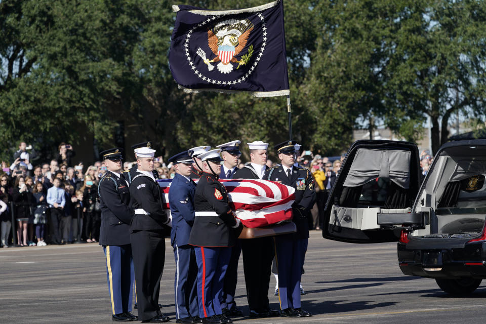 The flag-draped casket of former President George H.W. Bush is carried by a joint services military honor guard to Special Air Mission 41 at Ellington Field during a departure ceremony Monday, Dec. 3, 2018, in Houston. (Photo: David J. Phillip, Pool/AP)