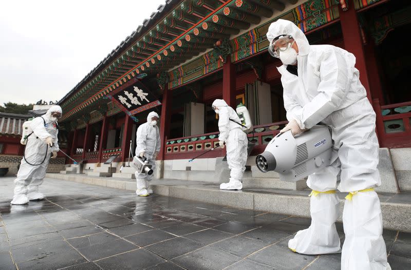 Officials from a public health center sanitize a traditional palace in Suwon