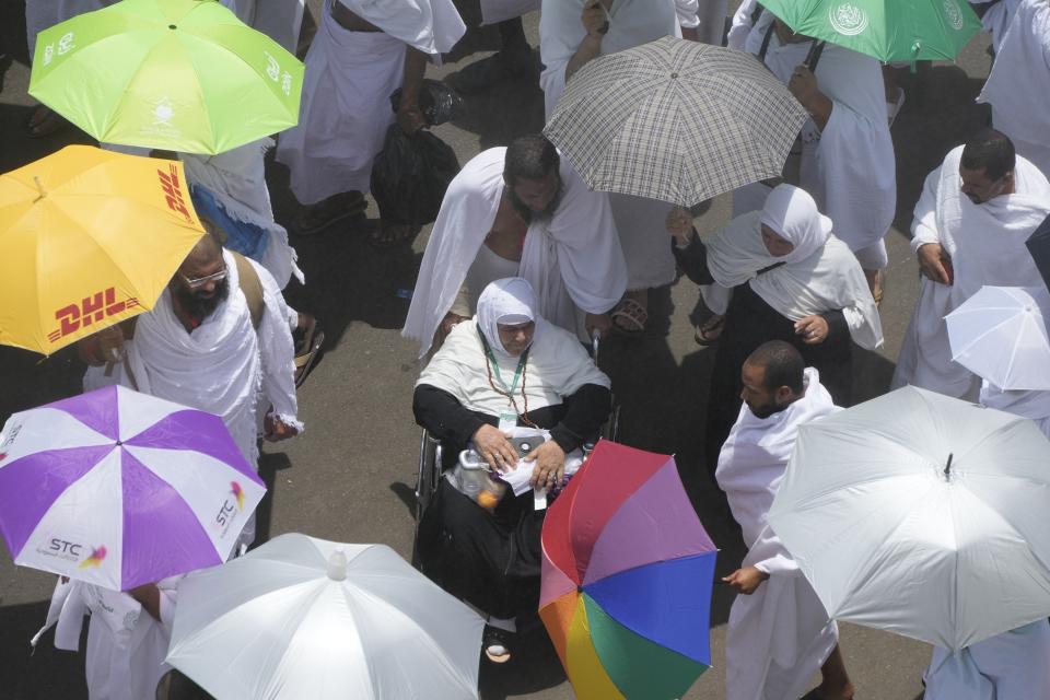 Muslim pilgrims move on their way to perform Friday Prayers at Namira Mosque in Arafat, on the second day of the annual hajj pilgrimage, near the holy city of Mecca, Saudi Arabia, Friday, July 8, 2022. (AP Photo/Amr Nabil)