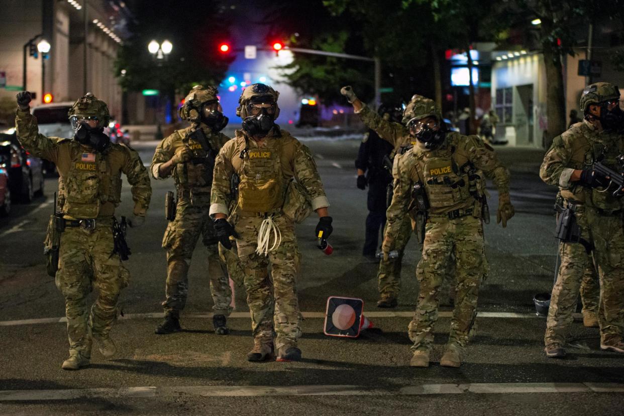 Federal law enforcement officers, deployed under the Trump administration's new executive order to protect federal monuments and buildings, face off with protesters against racial inequality in Portland, Oregon, U.S. July 18, 2020: Reuters