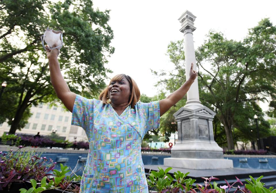 Denise Hunt, whose family goes back several generations in Jacksonville, celebrates the partial removal of the Confederate monument in what is now James Welcome Johnson Park across from City Hall in 2020.