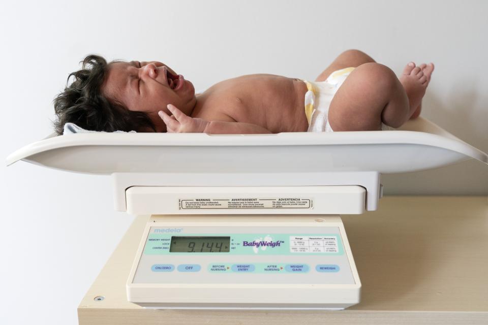 One-month-old baby Charlotte is weighed before attempting to breastfeed, Monday, May 23, 2022, during a lactation consultation in Columbia, Md., at Baby and Me Lactation Services. Babies are weighed before and after breastfeeding at the appointment to measure how much breastmilk they are receiving from their mothers. (AP Photo/Jacquelyn Martin)