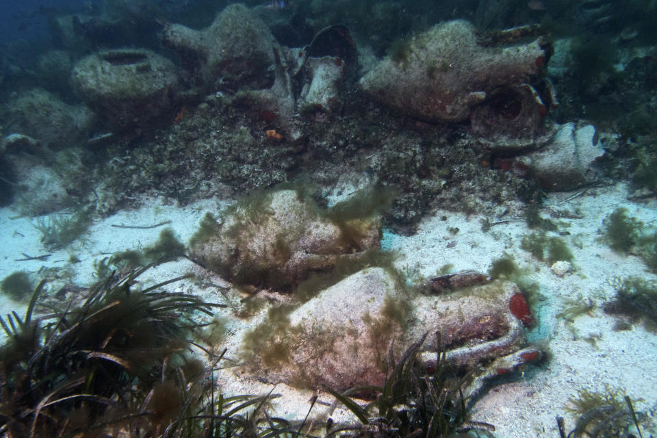 In this photo taken on Sunday, April 7, 2019, ancient amphoras lie at the bottom of the sea from a 5th Century B.C. shipwreck, the first ancient shipwreck to be opened to the public in Greece, including to recreational divers who will be able to visit the wreck itself, near the coast of Peristera, Greece. Greece’s rich underwater heritage has long been hidden from view, off-limits to all but a select few, mainly archaeologists. Scuba diving was banned throughout the country except in a few specific locations until 2005, for fear that divers might loot the countless antiquities that still lie scattered on the country’s seabed. Now that seems to be gradually changing, with a new project to create underwater museums. (AP Photo/Elena Becatoros)