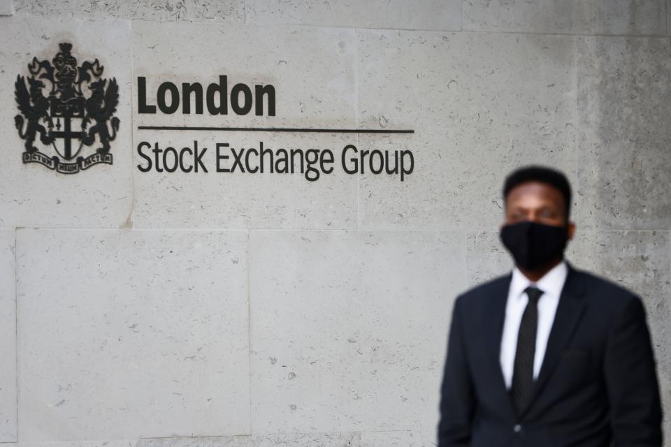 A security guard stands beside the logo for the London Stock Exchange Group outside the stock exchange in London on December 29, 2020. - The London stock market soared on December 29 as investors gave their initial verdict on Britain's Brexit deal with the EU, while eurozone equities also rose on upbeat US stimulus news, with Frankfurt extending its record breaking run. (Photo by Tolga Akmen / AFP) (Photo by TOLGA AKMEN/AFP via Getty Images)