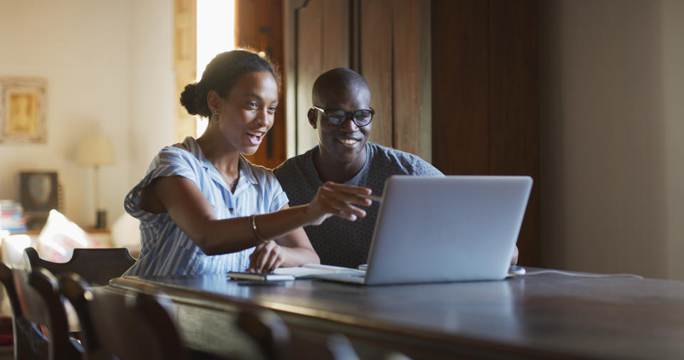 Happy couple, laptop and financial banking online for investment growth, accounting data and savings. African woman, man and computer for budget planning, insurance or review mortgage payment at home