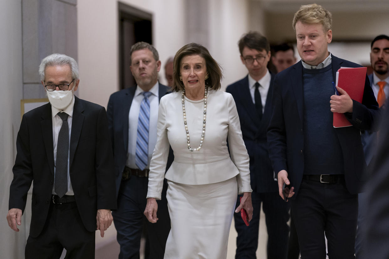 Speaker of the House Nancy Pelosi, D-Calif., walks with her staff and security to update reporters as Congress moves urgently to head off a looming U.S. rail strike, during a news conference at the Capitol in Washington, Thursday, Dec. 1, 2022. (AP Photo/J. Scott Applewhite)