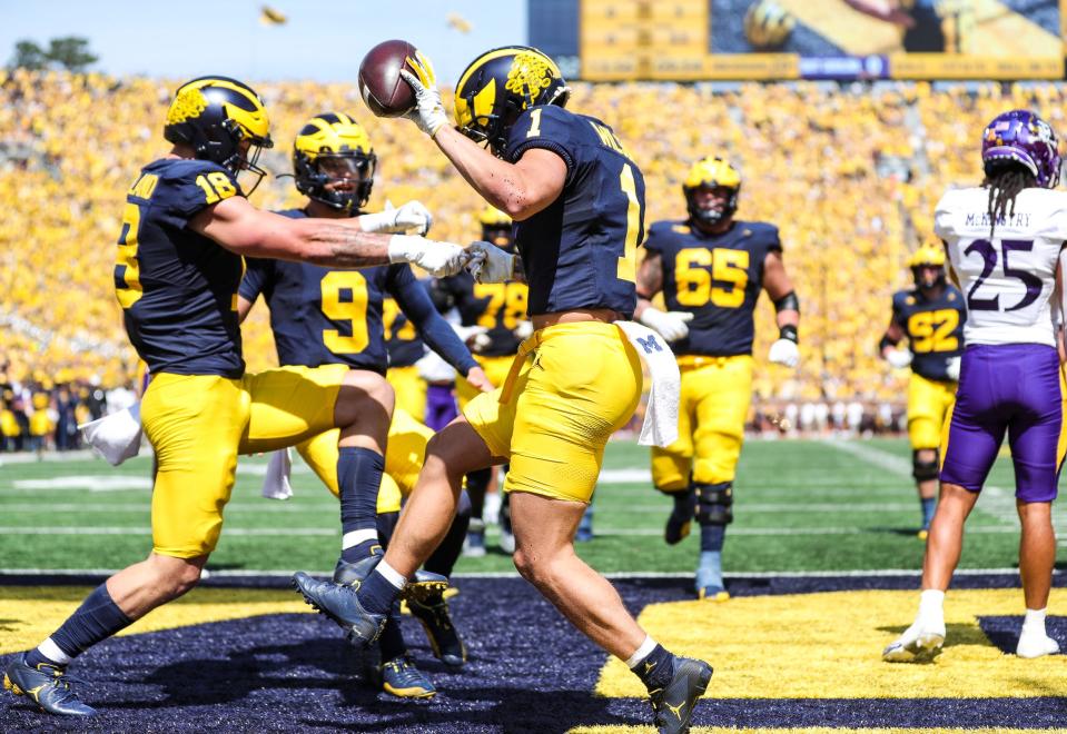 Michigan wide receiver Roman Wilson (1) celebrates a touchdown against East Carolina with tight end Colston Loveland (18) during the first half at Michigan Stadium in Ann Arbor on Saturday, Sept. 2, 2023.