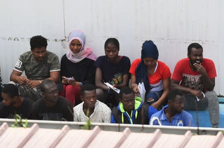 Migrants, some of whom disembarked from Spanish rescue ship Open Arms NGO, are seen at the immigration centre on the southern Sicilian island of Lampedusa