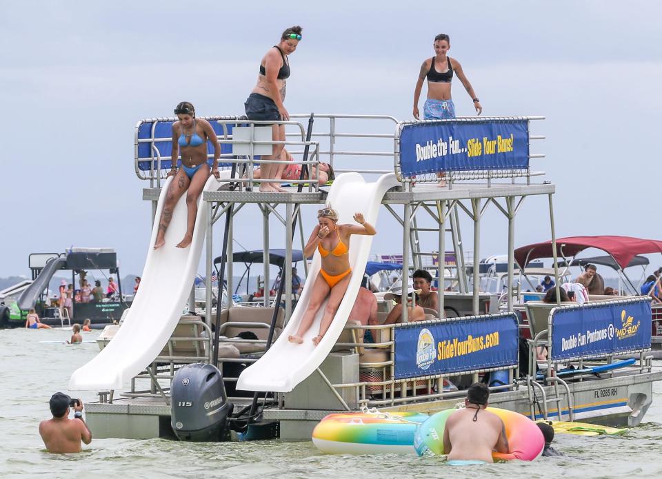 People enjoy a water slide on Crab Island. The popular party spot will get attention from law officers this weekend.