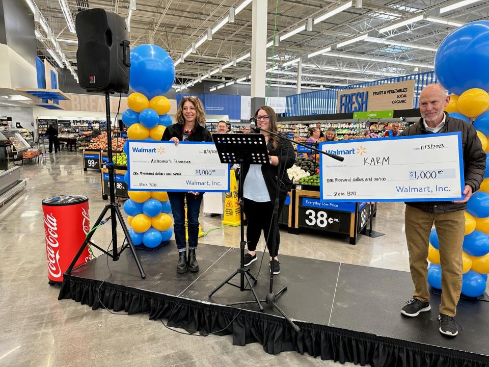 The ceremony included grants to local community organizations. Store manager Jessica Cecil, center, presents $1,000 checks to Alzheimer's Tennessee and KARM.
