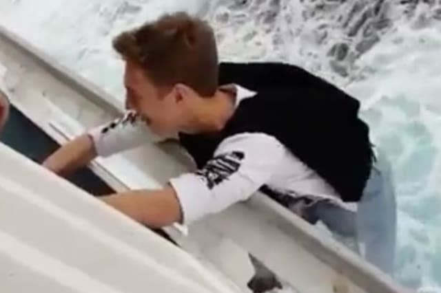 Teenage daredevil hangs from edge of cruise ship