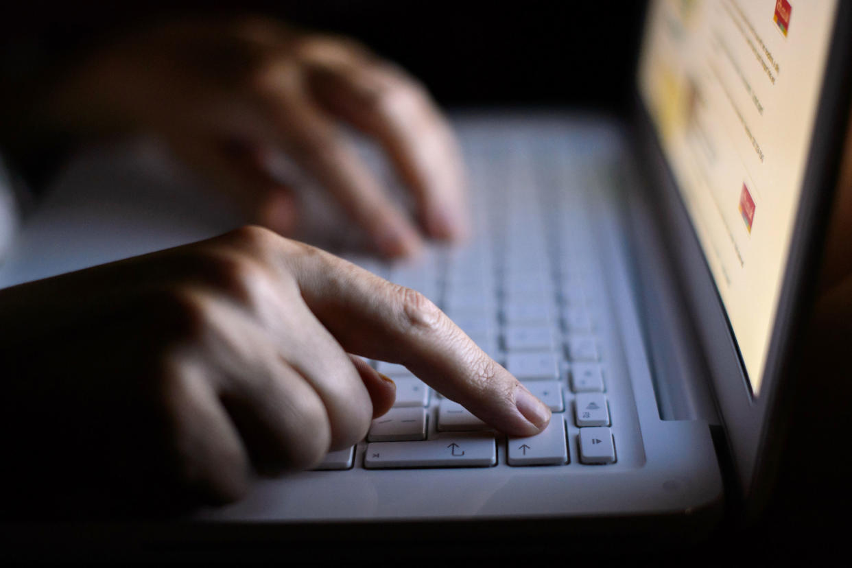 File photo dated 06/08/13 of a woman using a laptop. UK students are at risk from email scams because many top universities are not following best practices to block fraudulent emails, new research has claimed.