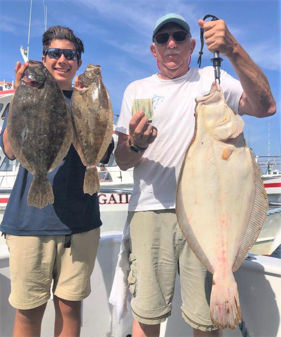Jack Guarnaccia, right, with his grandson Max Namba, holds the 9.75-pound summer flounder he caught during the Rhode Island Saltwater Anglers Association fluke trip last weekend.