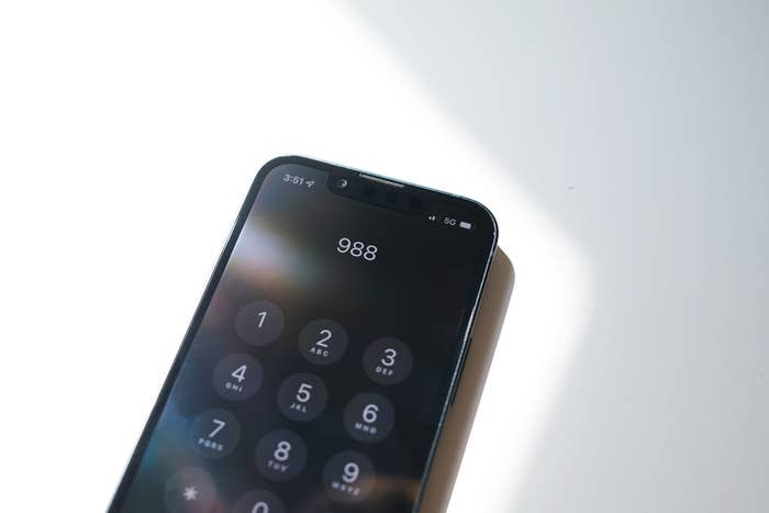 "988" is displayed on an iPhone screen