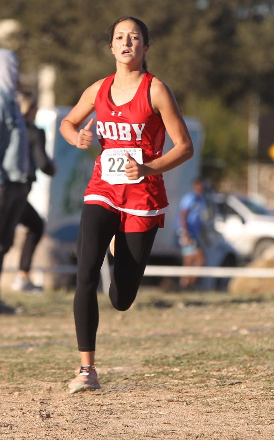 Roby Hailee Garmer rounds the curve and heads for the finish line in first place in the girls division at the Region II-1A Cross Country Championships on Oct. 25 at the Angelo State University Intramural Fields.