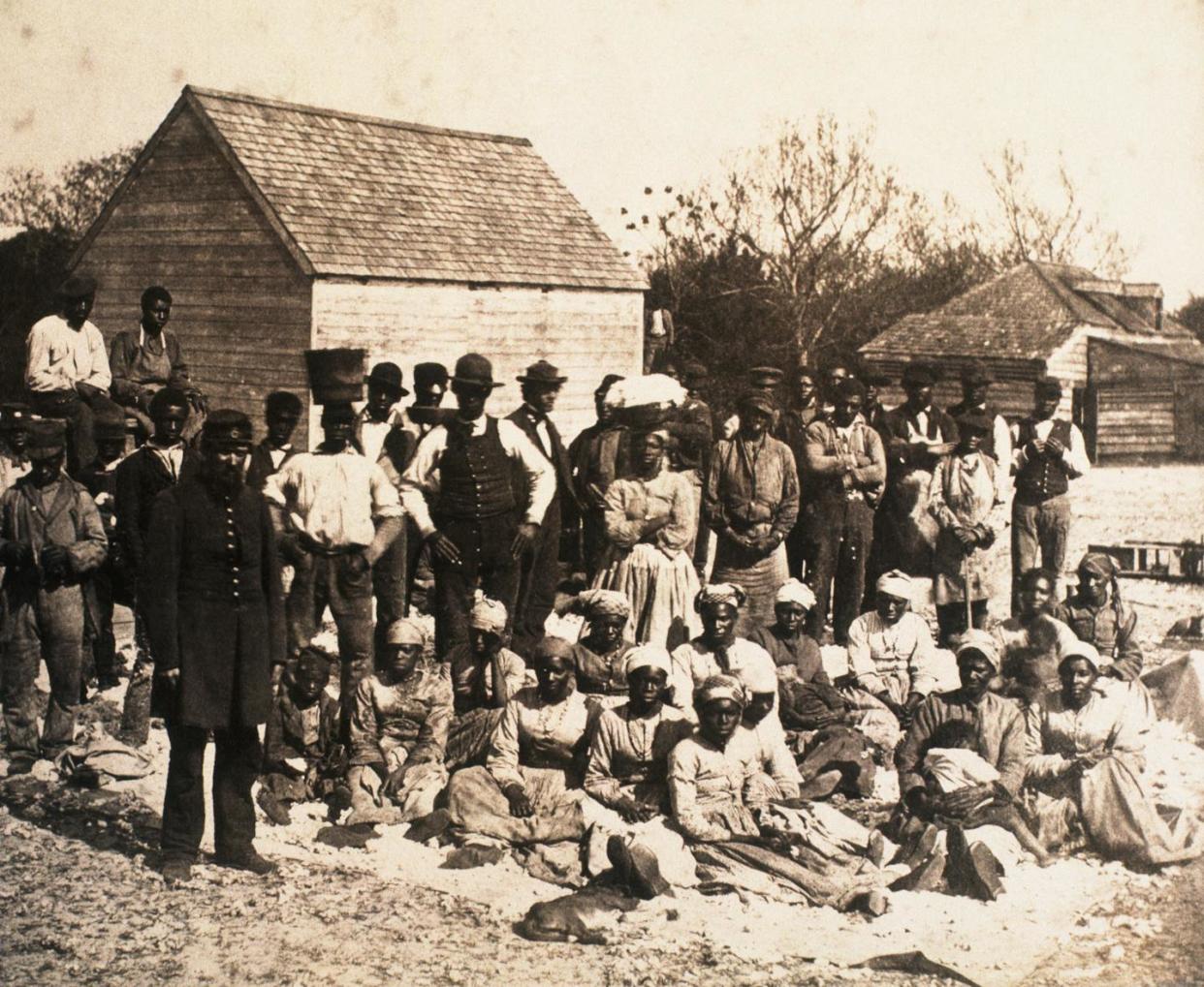 A group of formerly enslaved people gather on a South Carolina plantation during the Union occupation in 1862. <a href="https://www.gettyimages.com/detail/news-photo/group-of-freed-slaves-gather-on-the-plantation-of-news-photo/615304338" rel="nofollow noopener" target="_blank" data-ylk="slk:Corbis/ Getty Images;elm:context_link;itc:0;sec:content-canvas" class="link ">Corbis/ Getty Images</a>