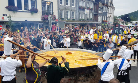 Members of the worldwide fraternity of the omelette prepare a traditional giant omelette made with 10,000 eggs in Malmedy, Belgium August 15, 2017. REUTERS/Christopher Stern